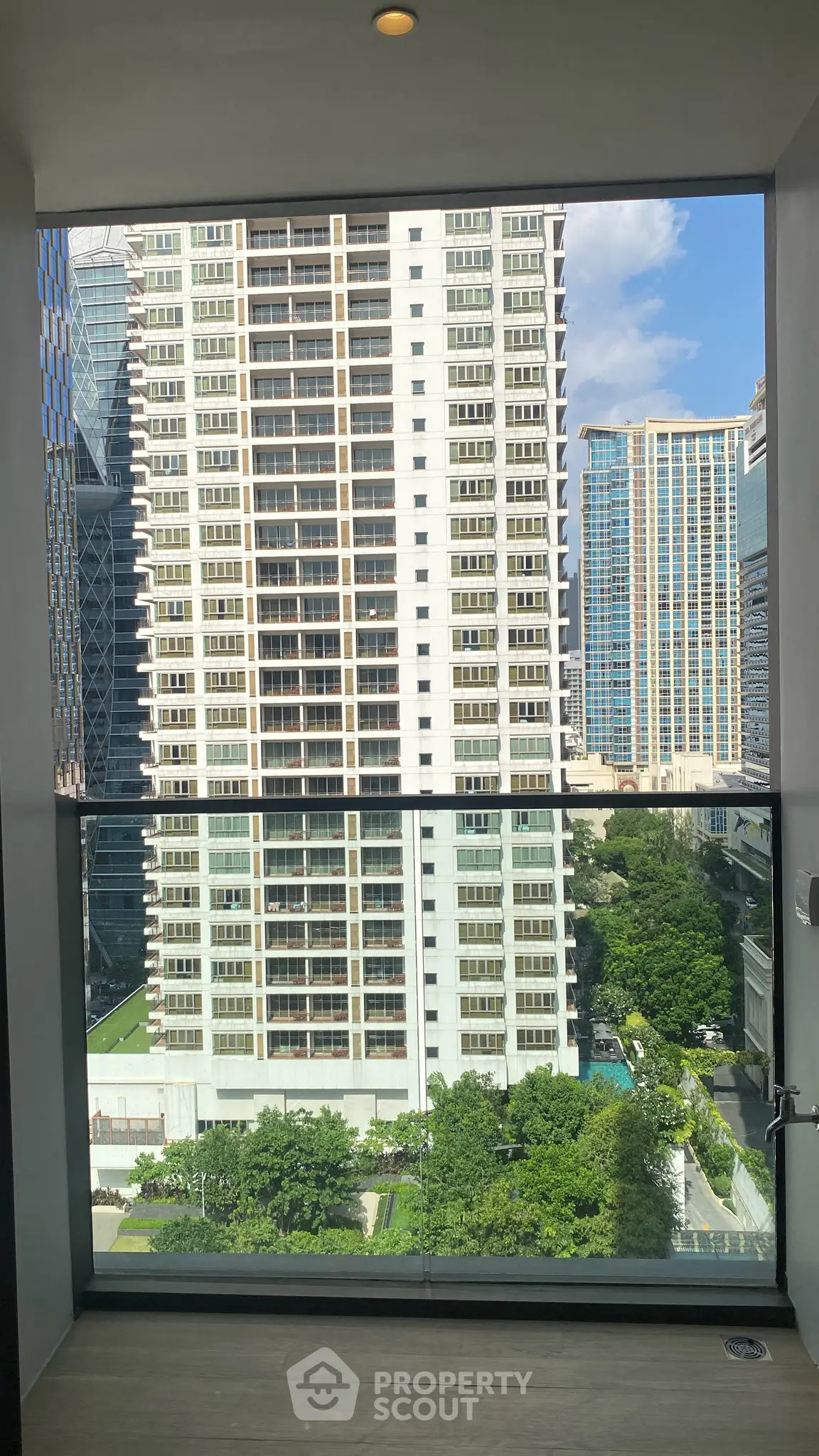 Stunning cityscape view from a modern balcony in a high-rise building, showcasing urban living at its finest.