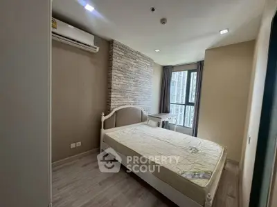 Modern bedroom with large window and air conditioning in stylish apartment.