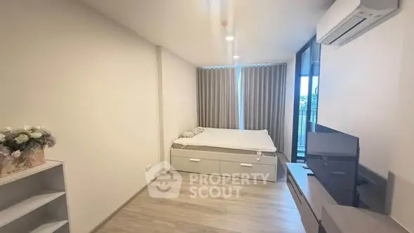 Modern bedroom with air conditioning and balcony view in a stylish apartment.