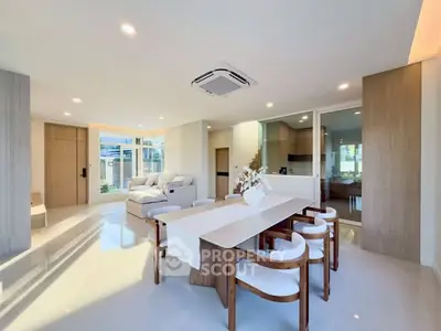 Spacious modern living room with elegant dining area and natural light