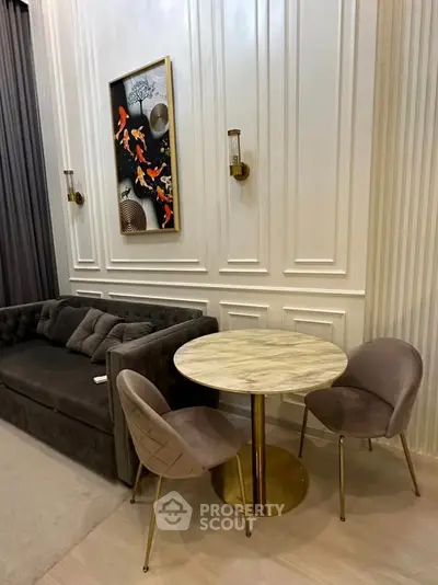 Elegant living room with plush sofa and chic dining set