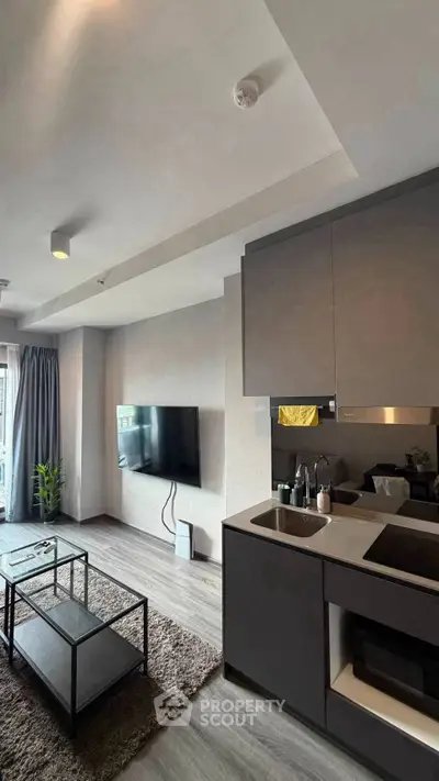 Modern open-layout living room with sleek kitchen and stylish decor