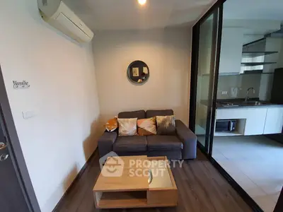 Cozy living room with modern decor and adjacent kitchen area