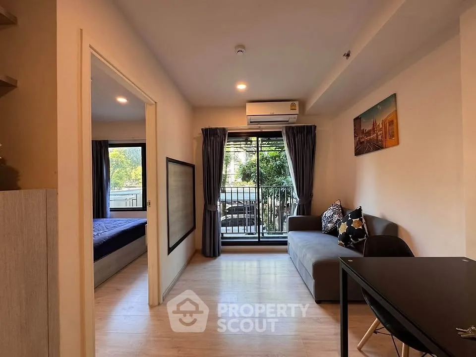Modern apartment living room with balcony and bedroom view