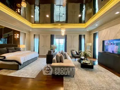 Luxurious master bedroom with elegant decor and spacious seating area