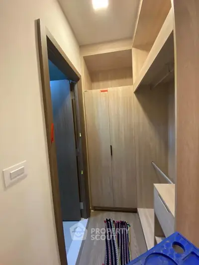 Spacious walk-in closet with modern wooden shelving and ample storage space.