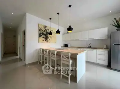 Modern kitchen with island and stylish lighting in spacious open layout