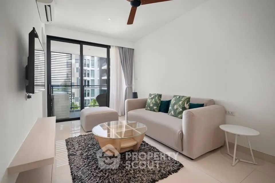 Modern living room with stylish decor and balcony view in a contemporary apartment.