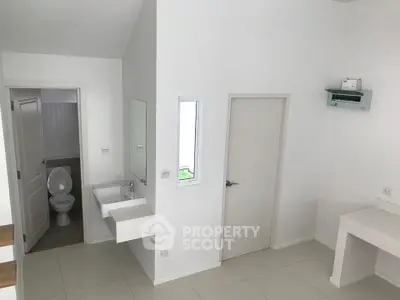 Modern minimalist bathroom with sleek white fixtures and clean lines