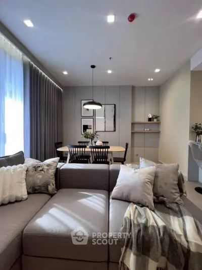 Modern living room with cozy sectional sofa and elegant dining area