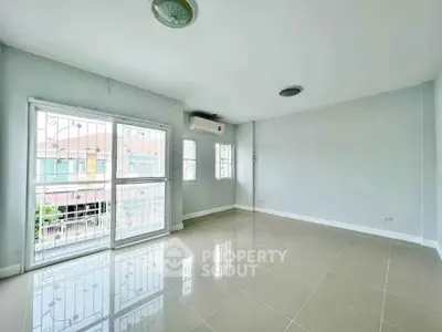 Spacious empty room with large windows and tiled floor, perfect for customization.