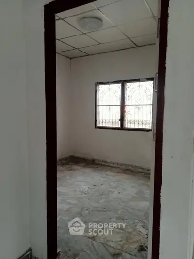 Spacious room with marble flooring and window view