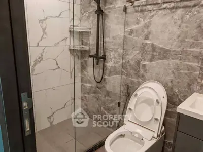 Modern bathroom with elegant marble tiles and sleek shower design