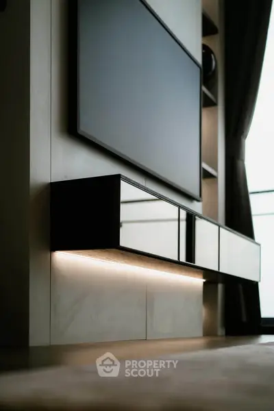 Modern living room with sleek wall-mounted TV and stylish storage unit