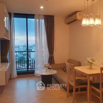 Cozy living room with city view, modern furniture, and elegant lighting.