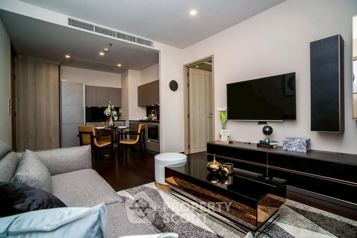 Modern living room with stylish decor and open kitchen layout in a contemporary apartment.