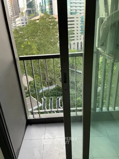 Charming urban balcony with lush green view in high-rise building