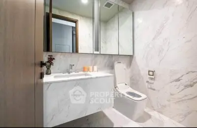 Luxurious marble bathroom with modern fixtures and elegant design.