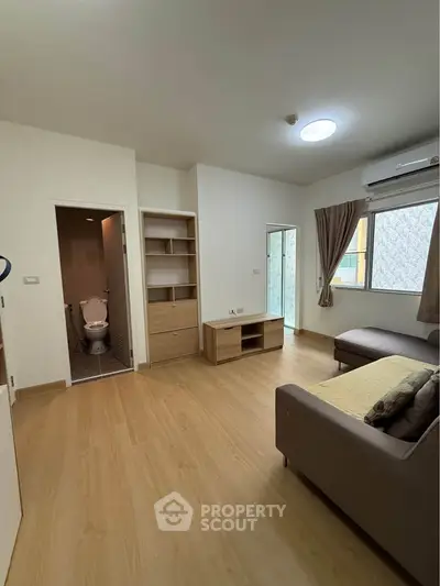 Spacious living room with modern furnishings and natural light
