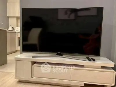 Modern living room with sleek TV and stylish furniture in a contemporary home setting.