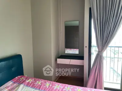 Cozy bedroom with balcony access and stylish vanity mirror