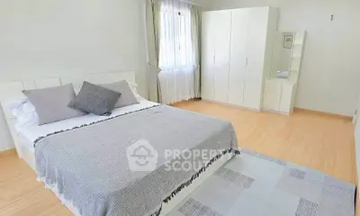 Spacious and bright bedroom with modern decor and ample natural light.