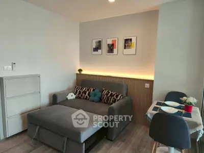 Modern living room with stylish sofa and dining area, perfect for cozy urban living.