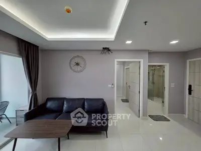 Modern living room with sleek black sofa and minimalist decor