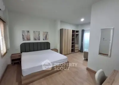 Spacious modern bedroom with stylish decor and ample storage space