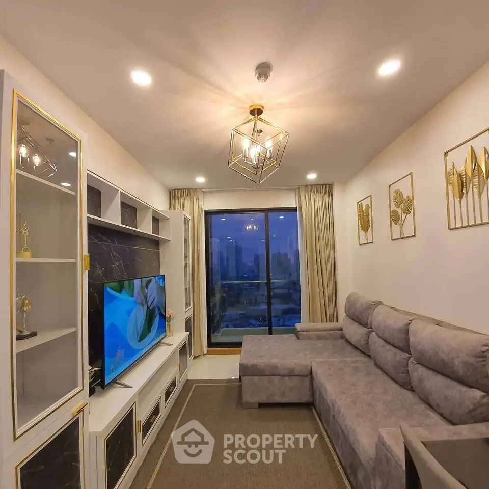 Modern living room with elegant decor and city view from large window.