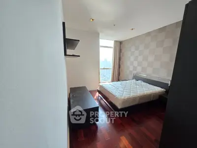 Spacious bedroom with city view and modern decor in luxury apartment