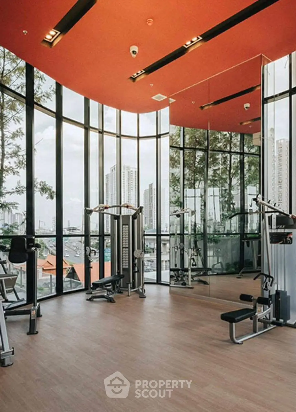 Modern gym with panoramic city views and state-of-the-art fitness equipment.