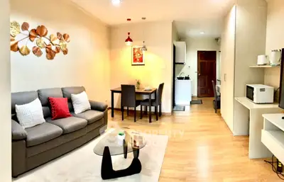 Cozy living room with modern decor and open kitchen layout, perfect for urban living.