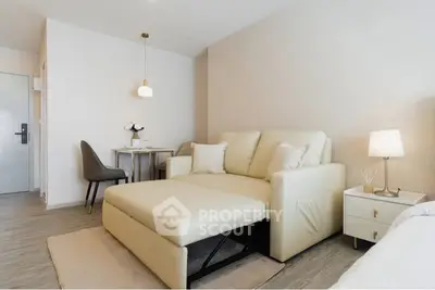 Modern living room with beige sofa, stylish decor, and cozy lighting in a contemporary apartment.