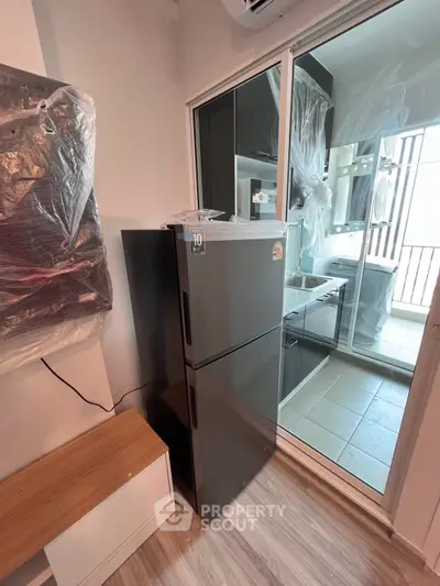 Modern kitchen with sleek appliances and balcony view in a stylish apartment.