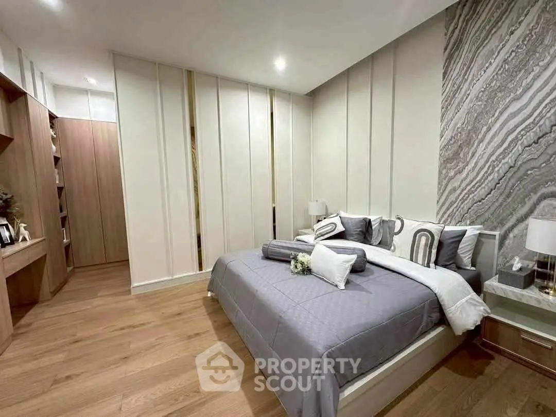 Luxurious modern bedroom with stylish decor and ample storage space.