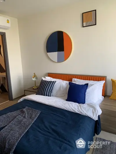 Modern bedroom with stylish decor and cozy bedding in a contemporary apartment.