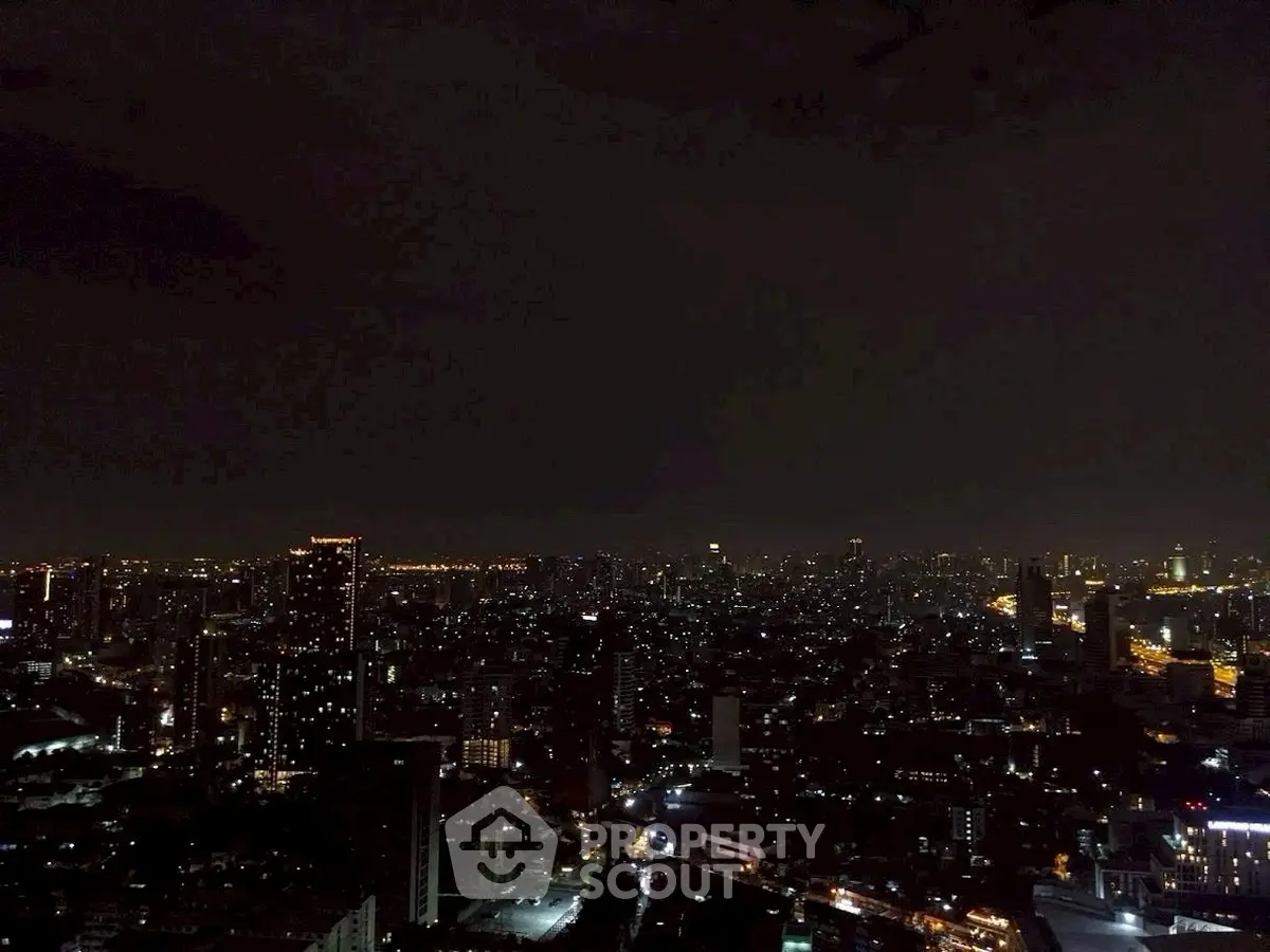 Stunning city skyline view at night with twinkling lights and skyscrapers.