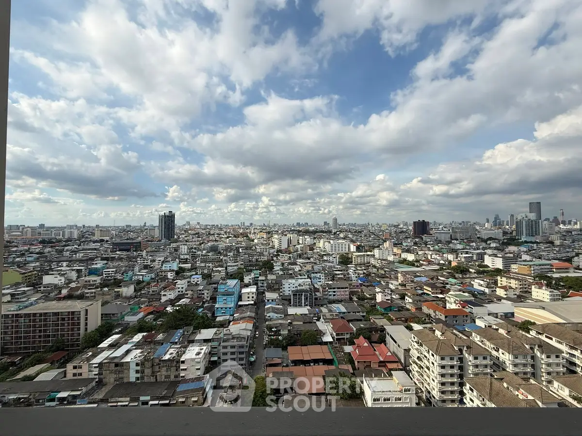 Stunning panoramic cityscape view from a high-rise building, showcasing urban skyline under a cloudy sky.