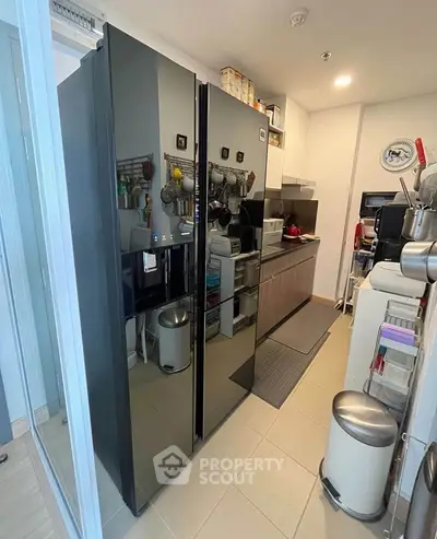 Modern kitchen with sleek black refrigerator and efficient storage solutions