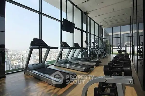 Luxurious high-rise gym with panoramic city views and modern fitness equipment.