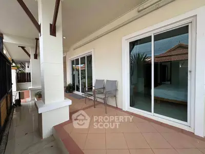 Spacious patio with sliding glass doors and seating area in modern home