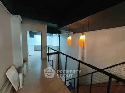 Modern interior with stylish lighting and open layout, featuring a mezzanine level and sleek design.