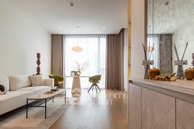 Elegant living room with modern decor, large windows, and stylish furniture in a luxurious apartment.