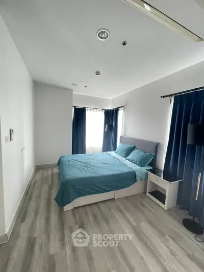 Modern bedroom with stylish decor and natural light