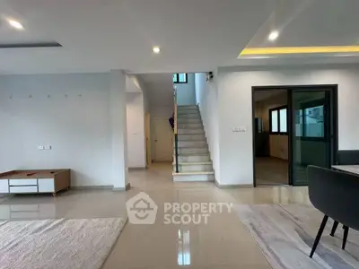Spacious modern living room with sleek staircase and open layout