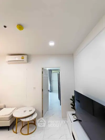 Modern living room with sleek TV setup and stylish furniture