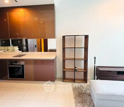 Modern open kitchen with sleek cabinetry and cozy living area in stylish apartment.