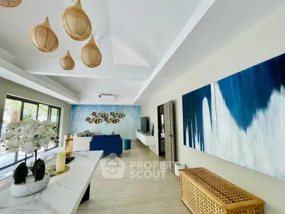 Spacious modern living room with stylish decor and large windows offering natural light.