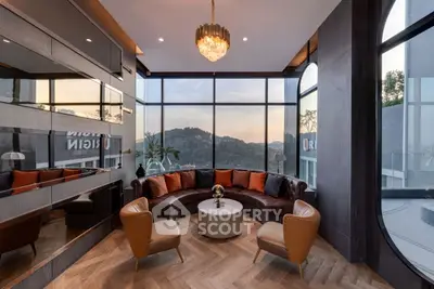 Luxurious living room with panoramic mountain views and elegant decor.